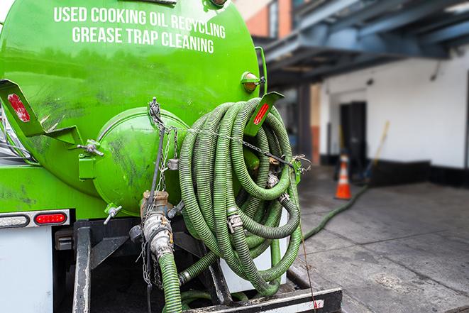 a professional technician pumping a restaurant's grease trap in Bealeton